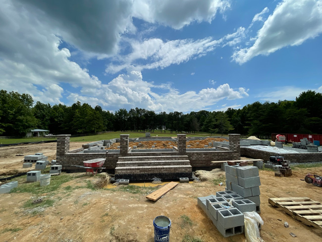 Masonry foundation being built with blocks and bricks for a new home build